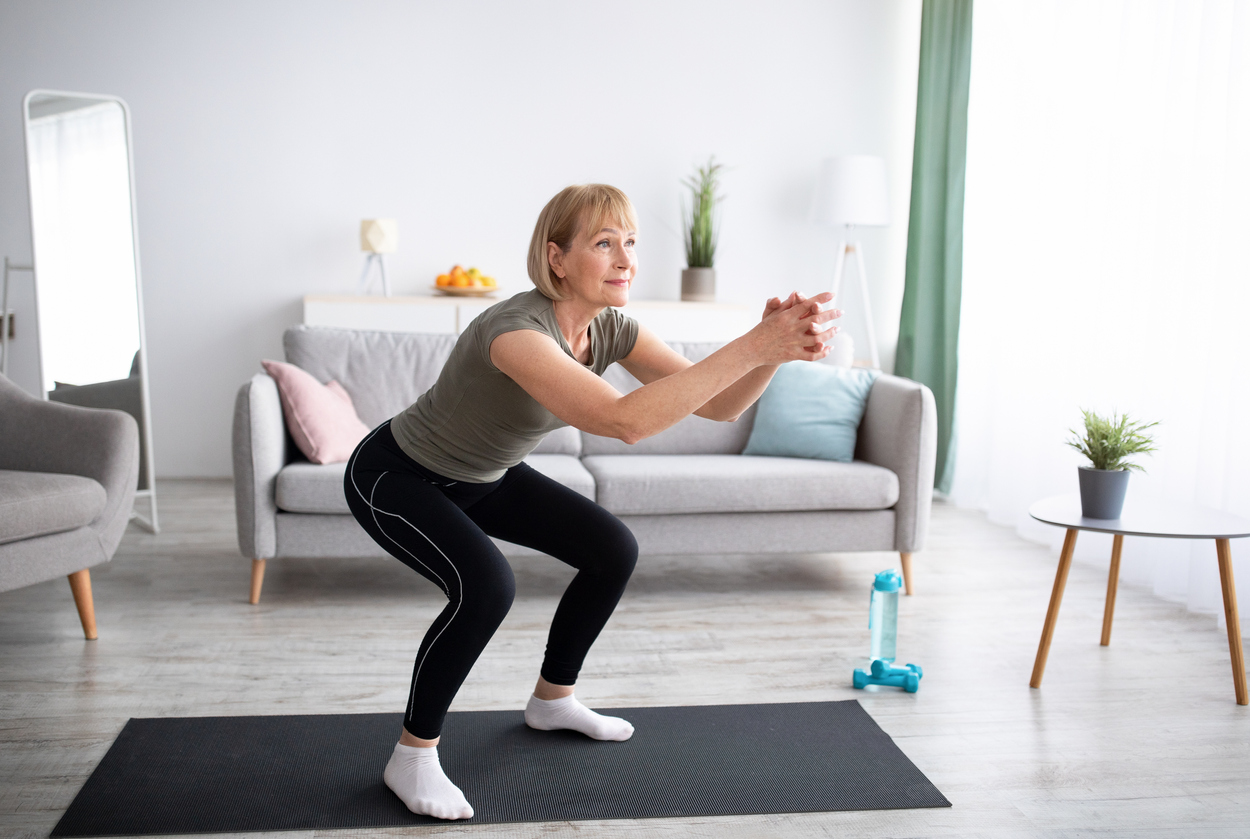 older woman does squat to relieve arthritis pain