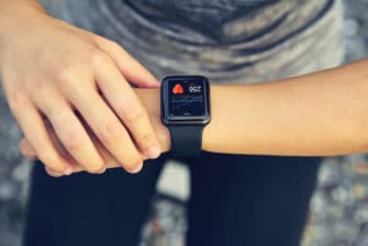 Woman tracks SMART fitness goals on smartwatch
