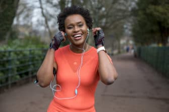 Female listens to music while she walks to improve mental health.