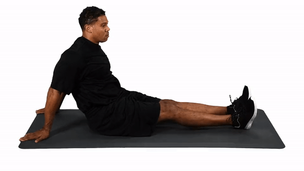 man performing lower back stretch