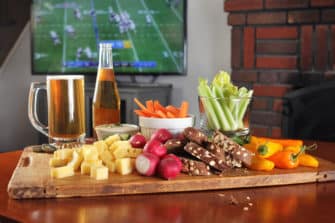Healthy super bowl snacks include a charcuterie board and beer.