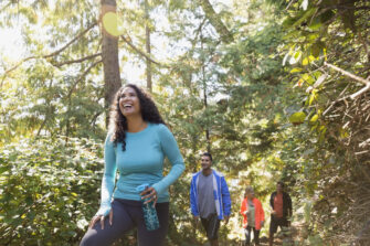 Group of hikers in the woods experience the benefits of hiking.