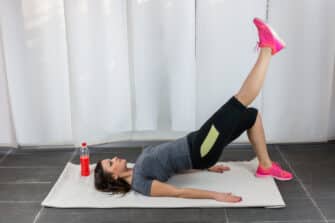 Woman does ab exercises during her home workout.
