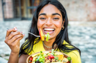 Woman enjoys a bowl of nutritious food as part of her healthy eating routine.