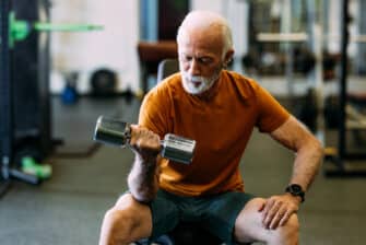 Older person with type 2 diabetes lifts weights to help manage blood sugar.