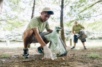 Man volunteers to pick up trash, giving back to boost his health.