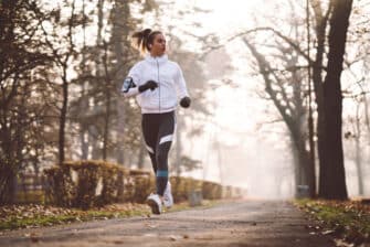 Woman runs in cold weather to stay active during winter.