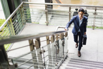 Businessman takes the stairs to get a short workout in during his day.