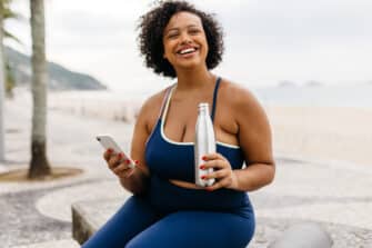 A woman rests after her workout and reflects on women's history in wellness.