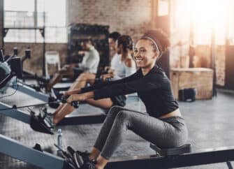 Woman uses a rowing machine as part of her cardio workout.